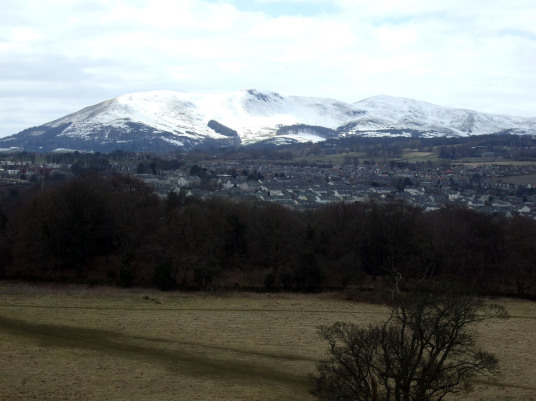 Snow covered Pentland Hills from Craigmillar Castle, a grand but ruinous castle with a large tower and two courtyards, held by the Prestons and the Gilmours, and associated with Mary Queen of Scots, in the Craigmillar area of Edinburgh.