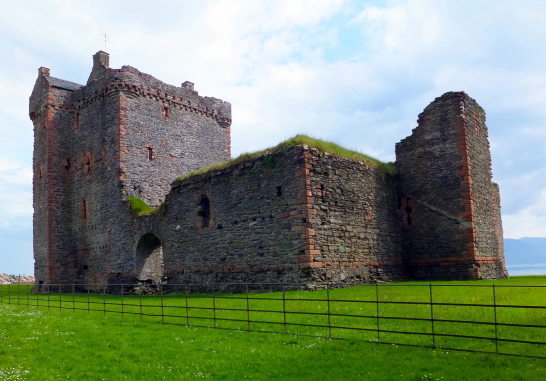 Skipness Castle, a large and scenic tower and courtyard overlooking Kilbrandon Sound and Arran, long held by the Campbells and near Tarbert in Kintyre on the west coast of Scotland.