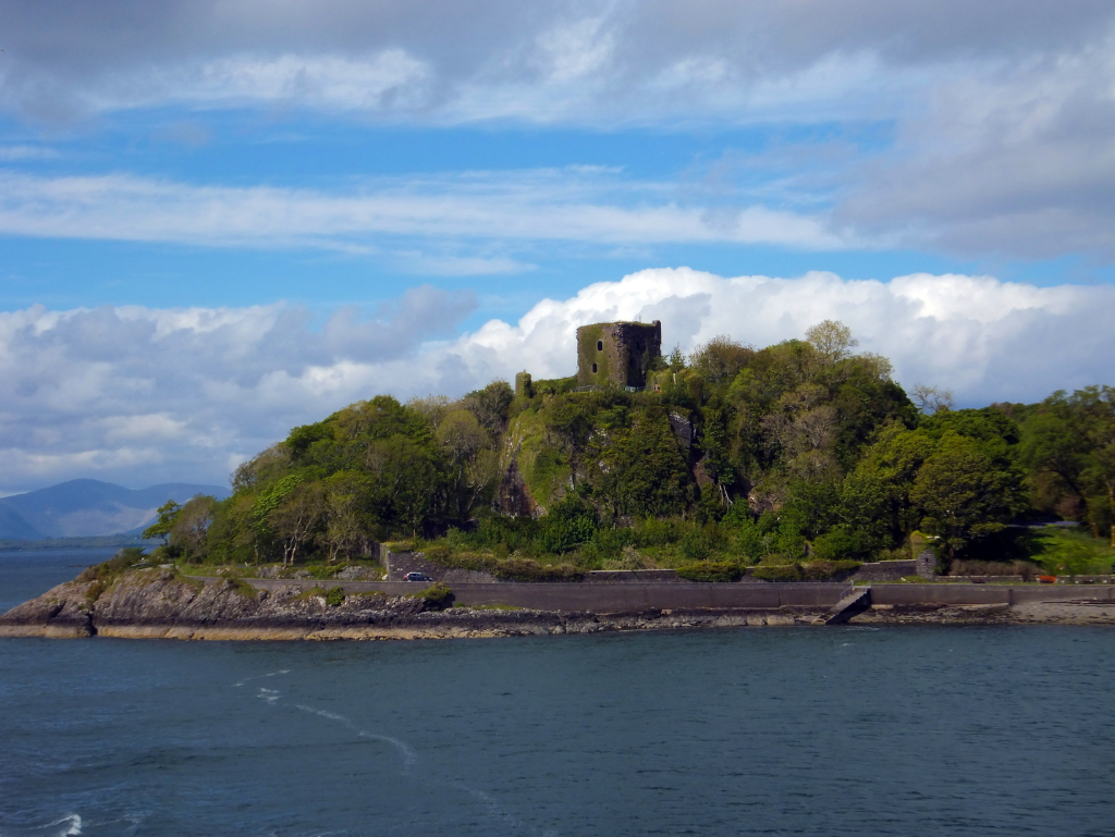 Dunollie Castle, an impressive ruinous tower on a prominent wooded spot above the later Dunollie House, long held by the MacDougalls, now with a museum, and near the seaside town of Oban in Argyll on the west coast of Scotland.