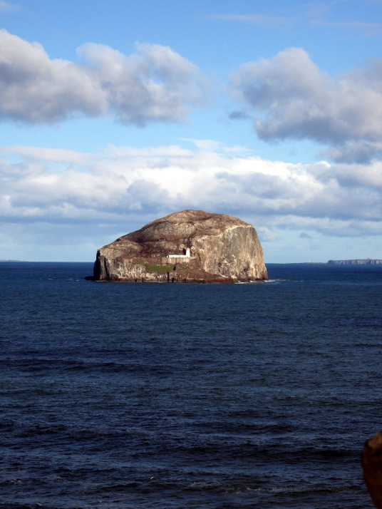 The Bass Rock is a large rock at the mouth of the Firth of Forth, with the remains of an old castle of the Lauders, later used as a prison and now home to many seabirds, near North Berwick in East Lothian in southeast Scotland.